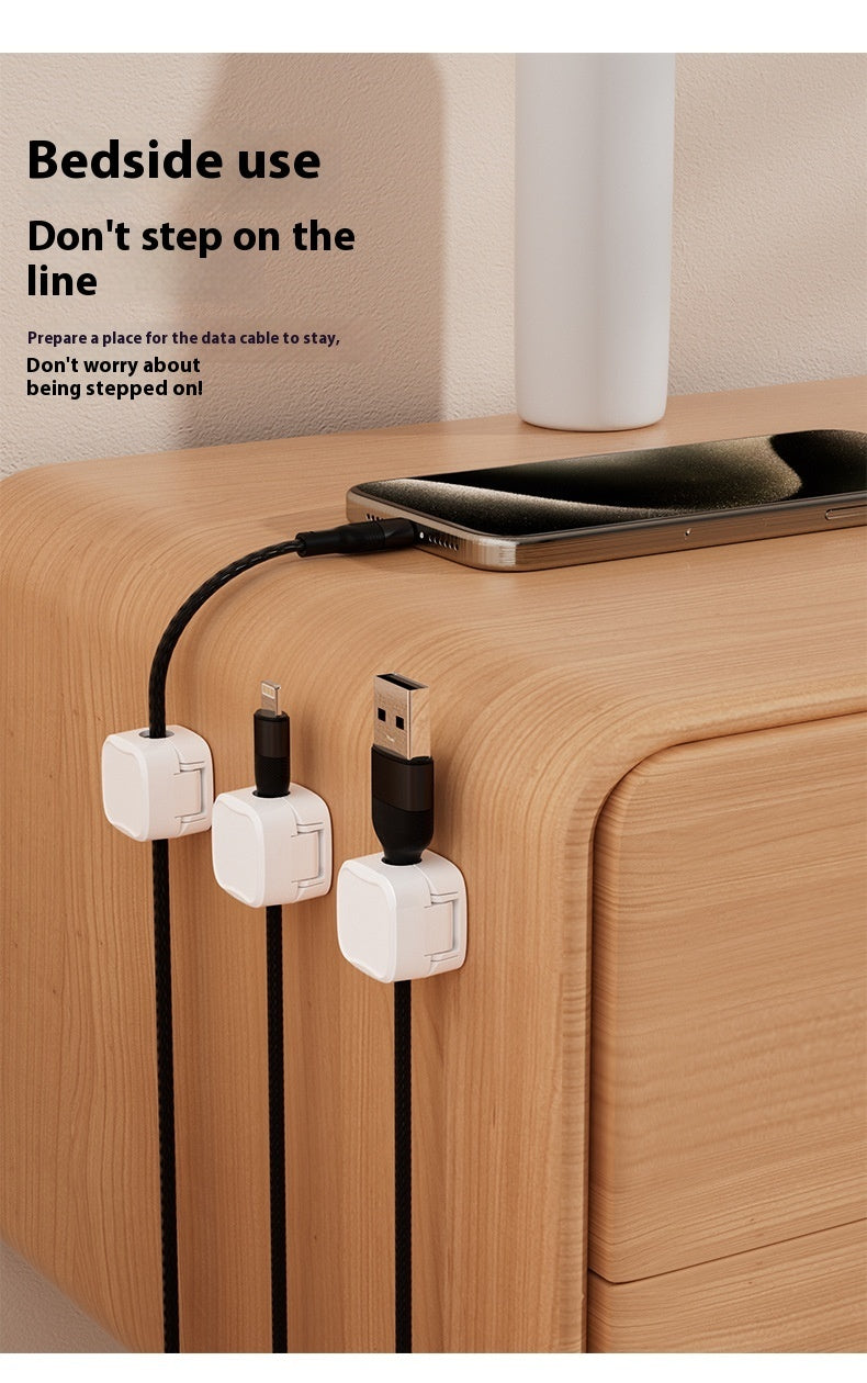 Charging cable holder attached to desk