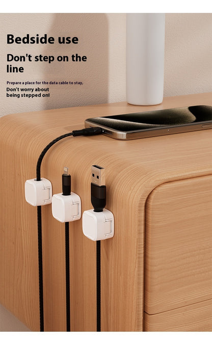 Charging cable holder attached to desk