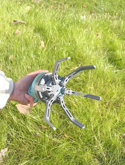 Person holding a metal tool against a grassy background